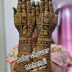A fun and full-coverage baby shower mehendi. The design is filled with cute cartoon baby faces and checkerboard patterns, perfect for a joyful celebration.