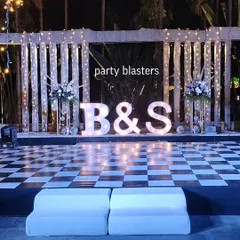 Let's make your Sangeet or reception truly personal with giant marquee letters of your initials. Paired with a checkered dance floor and dramatic lighting, this setup creates a fun, modern vibe that invites everyone to celebrate.