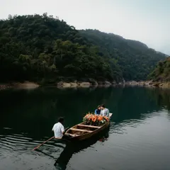 A serene and romantic scene of a couple in a flower-adorned boat on the tranquil waters of a Meghalaya lake. This wide shot captures the peace and intimacy of a private, nature-filled escape.