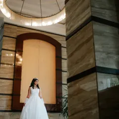 A grand setting for a beautiful bride. Her timeless makeup and hair look elegant and sophisticated, perfectly fitting the luxurious ambiance of her wedding venue.