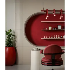 For this chic commercial space, I combined bold color with sophisticated textures. This nail station at Snob Salon features a striking crimson alcove, custom lighting, and plush seating, creating an indulgent and memorable client experience.
