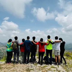 Standing together, looking out at the world. This is more than just a group photo. It's a snapshot of shared accomplishment, new friendships, and the kind of view that connects you to nature and to each other.