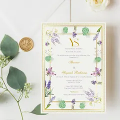 An elegant printed engagement invitation for Yogaesh and Shivani. The design features a beautiful border of watercolor purple blooms and tropical leaves, finished with a classic gold foil frame and a wax seal for a luxurious touch.