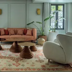 The den in Summer Haus, as featured in Elle Decor. The space was designed to be cozy and immersive, with rich colors and custom furniture that reflect the homeowners' creative spirit.