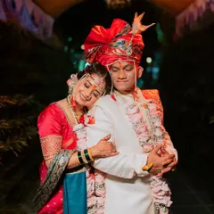 A tender moment captured at the end of the wedding day, with the bride resting her head on the groom's shoulder.