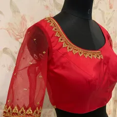 A simple and elegant red blouse with sheer net sleeves. The neckline and cuffs are finished with a delicate gold embroidered border.