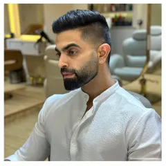 A clean and classic men's haircut and beard trim. This side profile highlights the sharp lines and expert fading that our stylists deliver.