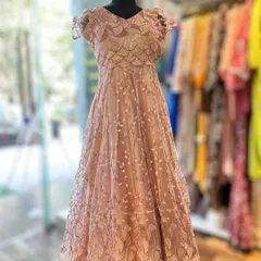 Perfect for a reception or formal event, this blush pink lace gown is the epitome of romance. The delicate lace overlay and cap sleeves create a soft, feminine look that is both timeless and sophisticated.