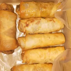 Classic Spring Rolls, available with both vegetable and non-vegetable fillings. They are fried until golden and crispy, perfect for passing around at any event.