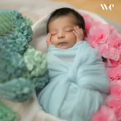 A classic, peaceful pose. We gently guide your baby into comfortable positions like this to capture their tiny features and serene expressions during their infant photoshoot.