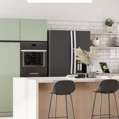 Tailored spaces for sophisticated living. This kitchen combines light green cabinets with a white subway tile backsplash and a wooden island base, creating a fresh, modern, and inviting atmosphere.