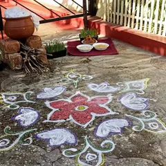 A beautiful rangoli and a traditional Pongal pot setup with firewood, ready for our celebration.