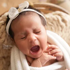 A perfectly timed capture of a big newborn yawn. These are the authentic, unscripted moments that add so much personality to your baby's first portraits.