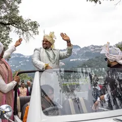 The groom's grand baraat entry in a vintage car, winding through the hills of Mussoorie. Capturing the journey is as important as the destination.