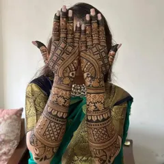 A beautiful back hand design with peacock and floral motifs. The fingers are fully covered, and the pattern extends up the arm with detailed bands of traditional artwork.