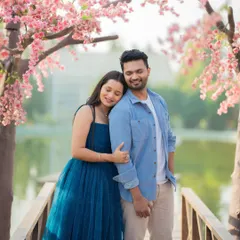 A dreamy pre-wedding portrait of Jui and Vaikrant on a bridge surrounded by cherry blossoms. This stylized set creates a beautiful and romantic atmosphere.