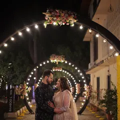 A couple shares a romantic moment under a tunnel of lights at their Sangeet. I design these immersive entryways to make the couple's entrance a magical and memorable part of the evening.