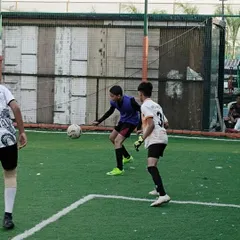 A one-on-one challenge near the box, highlighting the defensive pressure and ball control taught at our academy.