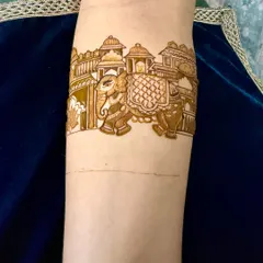 A detailed armband design featuring a royal elephant procession in front of a palace. This style is perfect for the upper arm or as part of a larger design.