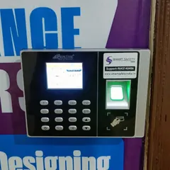 A close-up of the Realtime biometric machine at Anshika Institute. The device features both a fingerprint scanner and an RFID card reader, offering multiple ways for staff and students to gain access.