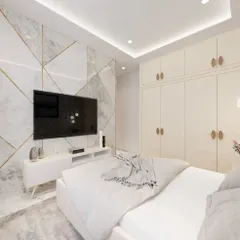 Here is the TV and wardrobe wall from the same bedroom project. The wall features a stunning marble-effect panel with gold inlay, and the wardrobe has minimalist handle designs for a clean, uncluttered look.