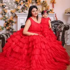 Seeing red in the best way possible. This mother and daughter duo look absolutely stunning in matching red layered gowns, perfect for a grand celebration or a festive photoshoot.