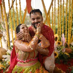 The playful messiness of a Haldi ceremony is part of the fun! We love capturing these candid moments of pure joy and celebration.