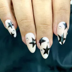 A close-up shot showing the clean lines of the hand-painted stars and the placement of the crystal accents. These stick-on nails are completely reusable and made to fit you.