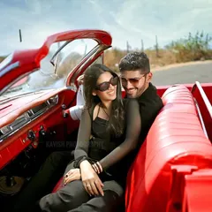 An intimate, candid moment of the couple sharing a laugh inside the vintage car, capturing their genuine connection during the pre-wedding session.