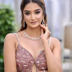 Modern elegance for a reception or cocktail night. This look features a dewy base, nude glossy lips, and muted pink lids with delicate rhinestone accents.