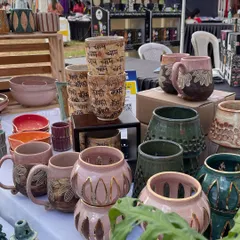 My stall featuring stacks of my popular 'Chai' and 'Coffee' cups, alongside hand-carved mugs and perforated luminaries. Markets are a great way to reach new people.