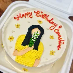 A sunshine-yellow bento cake with a hand-painted portrait to brighten someone's birthday. We love turning your photos and ideas into sweet, edible illustrations.