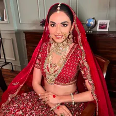 A close-up of this classic red bridal look, showing the soft contouring and radiant skin. The goal is always to make you feel confident and beautiful while honoring your heritage.