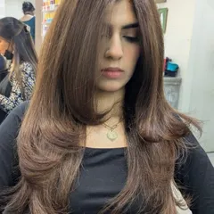 A closer look at this beautiful layered haircut. The feathered layers create amazing volume and movement, giving the hair a light and airy feel while maintaining its length.