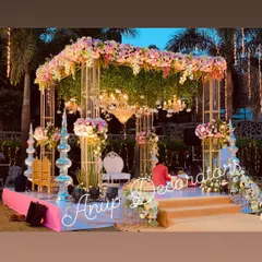 This destination wedding mandap in Lonavla features a modern box truss structure softened by a canopy of lush florals and an elegant chandelier. It perfectly blends contemporary design with romantic wedding decor.