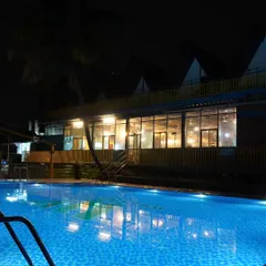 The pool at our Nandi Hills resort beautifully lit up at night, offering a serene and magical ambiance for an evening swim.
