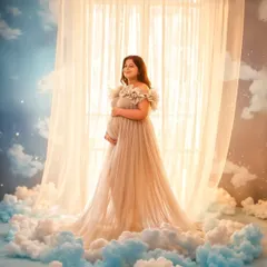 A truly heavenly shot in our Isabella gown. The "clouds at your feet" setup in our studio transforms your maternity photos into a work of art.