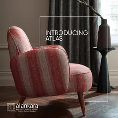 A beautiful armchair upholstered in a striped fabric from the Atlas collection, showcasing its rustic charm and modern elegance.