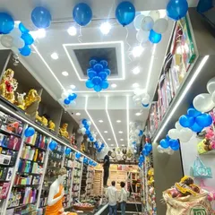 The interior of the "Giftie" shop decorated with blue and white balloon bunches on the ceiling to continue the festive opening theme.