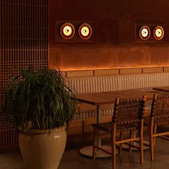 As evening sets in, the custom lighting at Biergarten creates a warm, ambient glow. The design highlights the natural textures of the wood and terracotta, transforming the space into a cozy retreat.