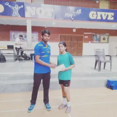 Presenting an award to another junior champion. Her focus and hard work are an inspiration to other young players.