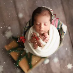 Baby's first Christmas. I love creating festive holiday-themed shots. This little one is wrapped up like a present with a tiny gingerbread man, ready for the most wonderful time of the year.