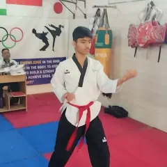 The intensity and focus required during a black belt test are immense. This student is demonstrating his mastery of the form.