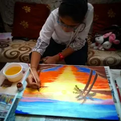One of my students is deeply focused on her acrylic painting of a sunset. In my classes, I encourage this level of concentration, which helps children develop patience and attention to detail.