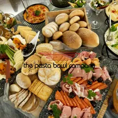 Our modern grazing tables are perfect for networking events. This spread features a curated selection of artisanal breads, imported cheeses, cold cuts, and fresh dips, designed to encourage interaction and conversation.