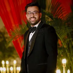 A classic portrait of the groom, Shivam, looking sharp in his tuxedo for the engagement party.