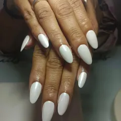 Them glazed nails. This is a simple, chic look using a pearly white polish on long, almond-shaped extensions.