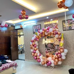 A wider view of the 'Bride to be' circular balloon setup in a living room, showing how it transforms the space for a party.