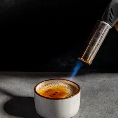 The perfect crackle of caramelized sugar. Our classic crème brûlée is torched to order, creating a warm, crisp topping over a cool, creamy custard. It's a moment of pure dessert theatre.