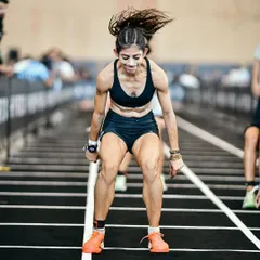 Burpee broad jumps are brutal, especially deep into a race. This shot captures the explosive effort required for every single rep. My coaching emphasizes building the stamina to maintain power even when you're fatigued.